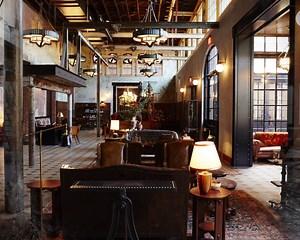 Step directly into the past in our spacious Lobby, which has been meticulously preserved from its earliest state as the Pearl Brewery’s engine room. Storied industrial details dating back to the early 1900s remain intact, including stout steel beams, rows of exhaust fans and windows, and the original fire engine red ammonia compressor that kept Pearl Brewing beer at a crisp 40 degrees. | Hotel Emma