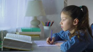 smart little school girl doing homework in mathematics