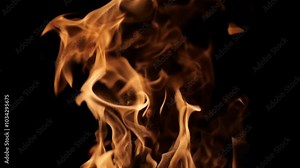 Flames of fire on a black background. A bonfire with sparks burns and warms. Fire texture.