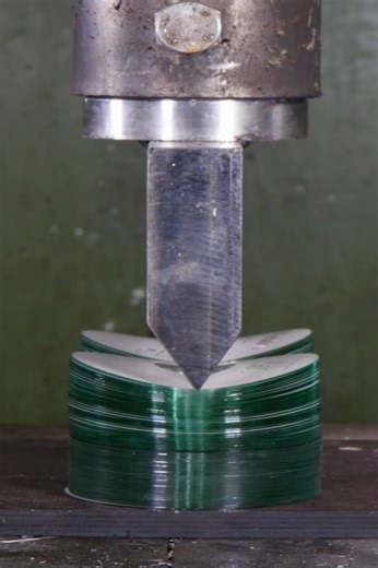 Stack of discs under hydraulic press