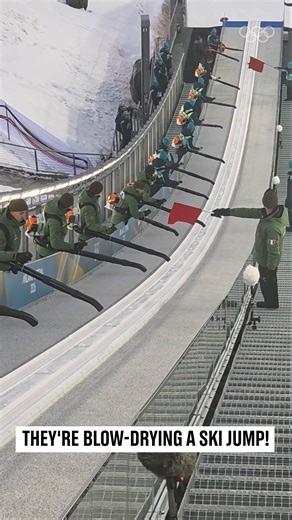 When a ski jump needs a blow-dry before competition, you don't mess about. This crew uses industrial leaf blowers to remove moisture and ice from the in-run—because at 90km/h, even a tiny patch of moisture can be dangerous. The Olympics aren't just about the athletes you see. They're about the hundreds of people behind the scenes making magic happen. #Olympics #SkiJumping #BehindTheScenes | Olympics