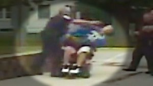 Cop pushes over man in wheelchair
