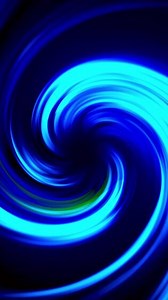 Gradient of rainbow colors are cyclically shifting, seamless loop. Motion. Beautiful abstract background with twisting light neon stripes.