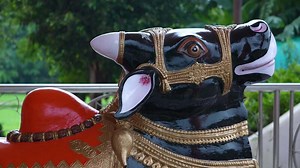 A statue of a cow with a gold head