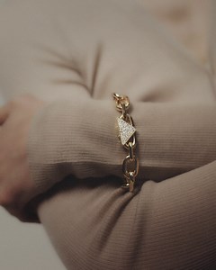4.5K views · 573 reactions | Channeling the importance of design through the utmost attention to the smallest detail, Prada Catena bracelet’s triangular clasp is set with 50 round, brilliant-cut, snow-set diamonds, adding dazzle to a faceted 18k recycled gold chain. Discover more at https://tinyurl.com/2p98mapd #PradaFineJewelry #Prada | Prada | Facebook