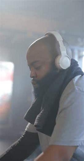 clip-4014392245-vertical-video-african-american-man-adjusting-console