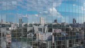 City and blue sky reflection in skyscraper facade windows aerial ascending