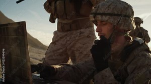 Soldiers are Using Laptop Computer and Radio for Communication During Military Operation in the Desert