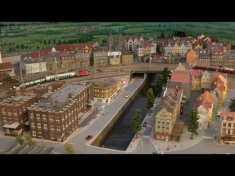 Model Railroad Display with Miniature Cars and Bumper Cars and 100 Trains in HO Scale