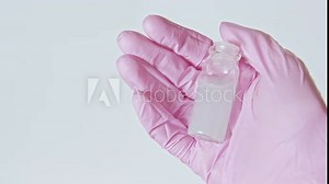 Antidote sample. Pharmaceutical drug. Hand in pink glove showing liquid solution in glass bottle isolated on white loop.