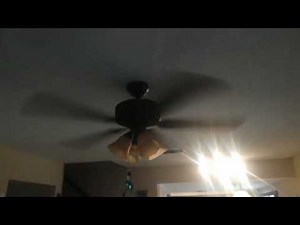 Black ceiling fan spinning fast