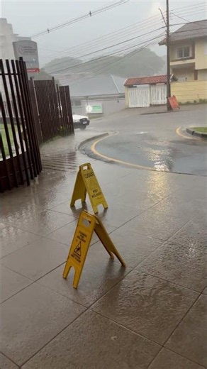 Sudden Downpour Floods Streets and Blows Over Sign