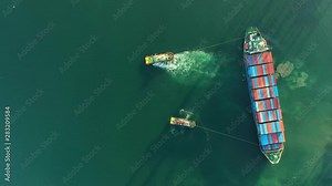 Aerial view. Container ship in pier with crane bridge carries out export and import business in the open sea. Logistics and transportation