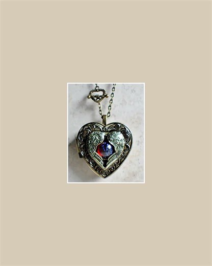 Angel wing music box locket, heart locket with music box inside with dragons breath cabochon.