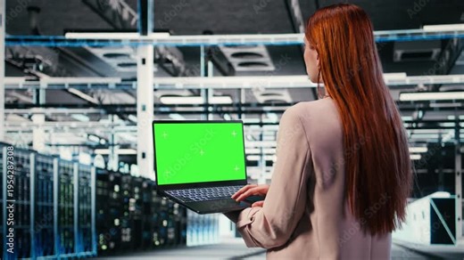 Green screen mockup laptop, machines and worker in server hub doing maintenance tasks. configuring settings, chroma key isolated screen notebook and IT expert in modern data center, camera A
