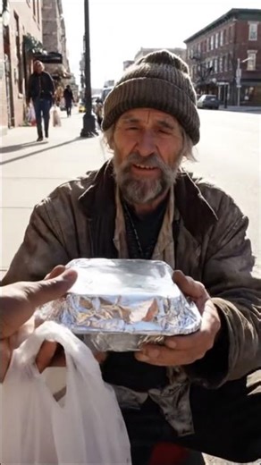 Giving Food To Homeless People On The Street