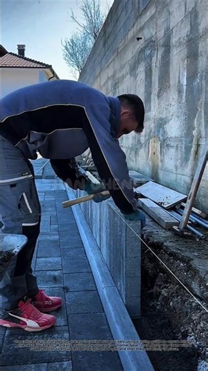 The concrete curb installation process uses a string guide to ensure a straight and neat position.