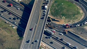 2 hurt as logging truck overturns, dumps load on I-405