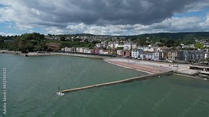 Dawlish, South Devon, England: DRONE VIEWS: An intercity train speeds along the seafront. Dawlish is a popular UK holiday destination well known for its resident population of black swans (Clip 6).