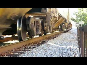 CSX train passing through Aberdeen, NC over railroad bridge at Aberdeen Creek close enough to touch