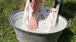 Washing a garment with a brush like in the old days on a washboard