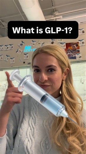 Asma Wahid on Instagram: "GLP-1 in International Sign featuring Arlene and Asma IMAGE DESCRIPTION: A person with blond hair and light blue sweater is smiling. The background is lab hood. The title says “What is GLP-1?” TRANSCRIPT: Do you see this woman explaining GLP-1? Do you understand the chemistry behind it? If not, I am here to explain! GLP-1 is like a messenger that communicates with cells. The body has many different types of cells everywhere. For example, muscles and the pancreas each ha