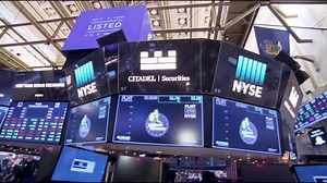 Dow hits record high, breaks 25,000