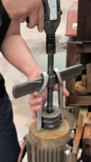 Two-jaw bearing puller being used to remove shaft, likely a pulley or a bearing #tools #shortsfeed