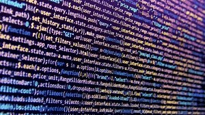 Scrolling motion dynamic move on notebook display. Lots of digits and chars on the computer screen. Software engineer at work creating computer programming source code