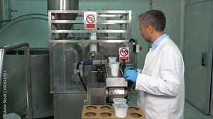 Dairy Plant Filler Operator at Work - Rotary Yogurt Cup Filling and Sealing Machine