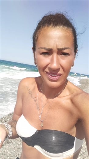 Beach Pose: Woman Showcases Strength in Sunny Setting