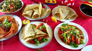 A vibrant display of colorful food items on a table, showcasing a festive atmosphere and shared dining experience.