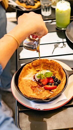 Zuzu’s Petals Long Beach on Instagram: "POV: You’re drizzling fresh maple syrup onto a warm Dutch Baby Pancake. 🥞⁠ ⁠ Served with fresh berries, powdered sugar, and creme fraiche!"
