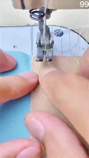 Sewing machine needle stitches fabric, presser foot guides seam with precise allowance markings.