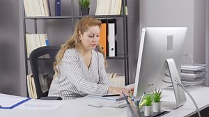 Elderly business woman has a headache. Office worker old business woman has a headache.
