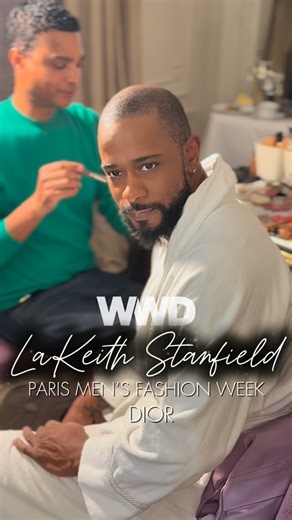 WWD on Instagram: "LaKeith Stanfield was still shaking off jet lag when he sat in the makeup chair to prep for the Dior menswear show. Swaddled in a fluffy white bathrobe, the multihyphenate Oscar nominee prepped with the mononymous makeup artist Angloma — “the best in Paris, I swear,” he promised — to the sounds of Etta James. The 12-hour time difference didn’t stop him from diving headfirst into the moment, jumping on the bed, playfully unfurling the pieces and directing camera cuts. His next 