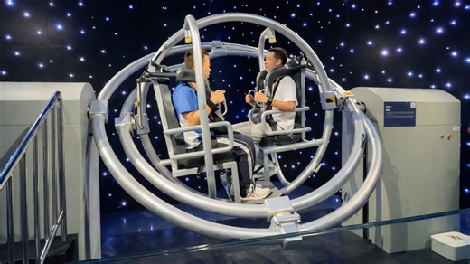 People try rotating space simulator machine inside China museum