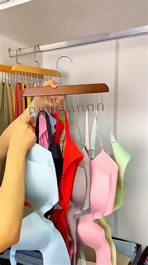Clothes hanger with hooks for organizing wardrobe.