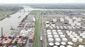Container and silos in the Port of Rotterdam heavy industry and transportation along the Oude Maas Petroleum harbour aerial drone overview.