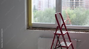 Repair in the slopes of the window. The process of applying a layer of plaster on the sides of the window.