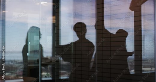 Business people, walk and silhouette in office, shadow and paperwork with partnership, laptop and window. Employees, documents and reading with reflection, phone and conversation in dark workplace