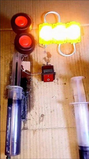 Lighting Three Yellow Lights Using Two Wheels and Two Motors as a Generator.