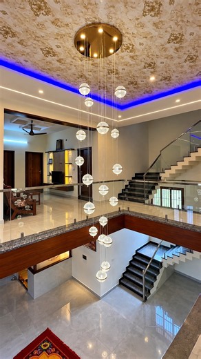 A stunning duplex interior featuring an elegant staircase, luxurious chandelier beautifully designed