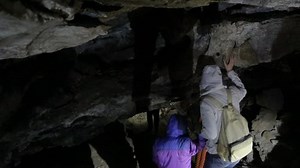 People walking through the cave