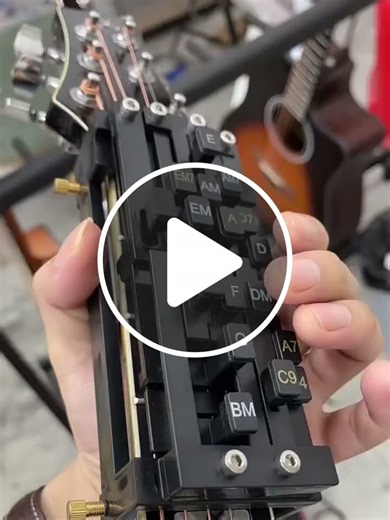 A device that attaches to a guitar, using buttons to press chords, simplifies learning. - NewsBreak