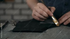 Shoemaker in workshop making leather shoes. Man close up seewing machine macro glue factory boots handmade
