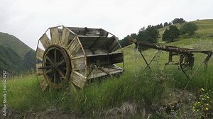 Ancient wood tedding machine (hay turner) on the mountain hayfields of the North Caucasus (Karachay-Cherkessia