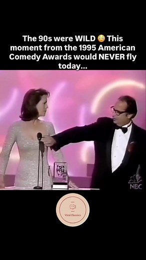 When Jamie Lee Curtis accepted her award at the 1995 American Comedy Awards, she got WAY more than a trophy 👀 While she’s saying “it’s so big and so heavy,” John Lovitz’s hand comes INTO FRAME and... well, let’s just say the crowd went INSANE 😂 Plot twist: It was actually REHEARSED and reportedly Jamie’s idea! She fires back immediately, the audience loses it, and John quips “you missed” 💀 This moment perfectly captures how different comedy was in the 90s - what was considered “edgy humor” th