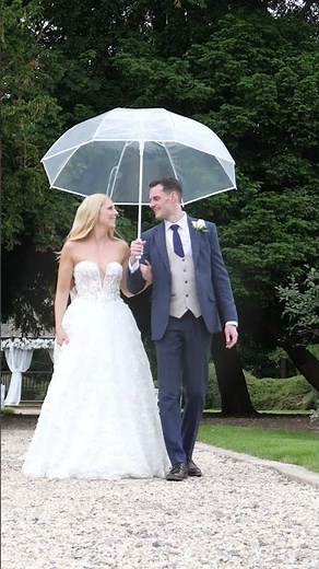 Bride & Groom Walking under an umbrella