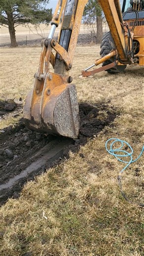 480 CASE backhoe taking frost at the graveyard